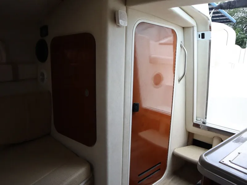 Slide: The Image of Interior of 2008 Sea Ray 240 Sundancer with wooden door. - 25