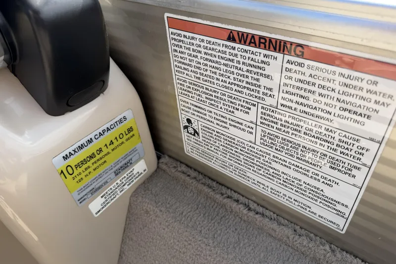 Slide: The Image of 2015 Starcraft Stardeck 216 Cruise-N-Fish warning labels and capacity limits, 10 persons or 1410 lbs. - 17