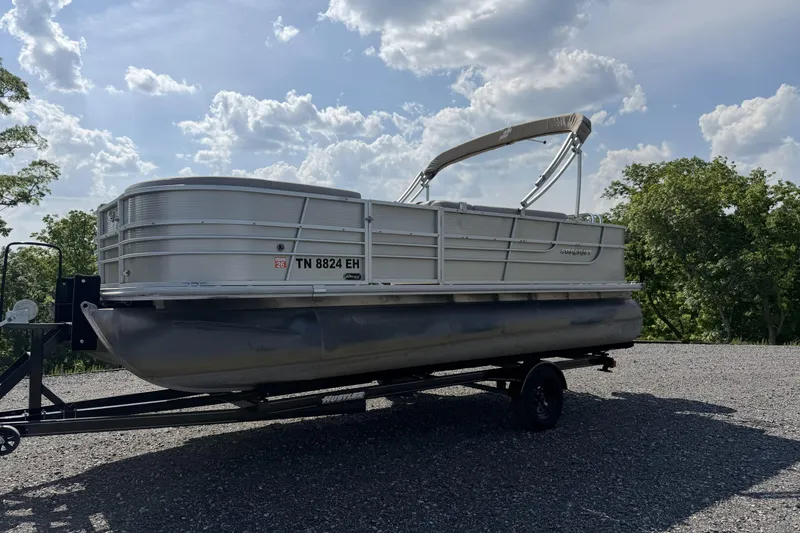 Slide: The Image of 2015 Starcraft Stardeck 216 Cruise-N-Fish pontoon boat on trailer under a cloudy sky. - 6
