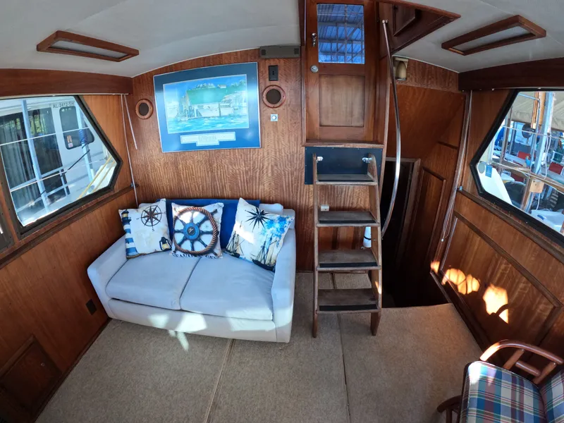 Slide: The Image of Interior of a 1976 Hatteras 38 Double Cabin yacht with sofa and stairs. - 10