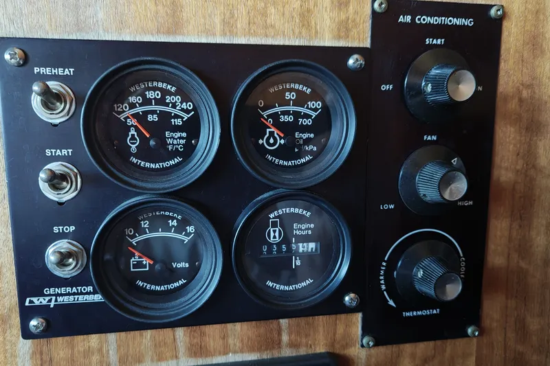 Slide: The Image of 1976 Hatteras 38 Double Cabin dashboard with gauges and controls. - 20