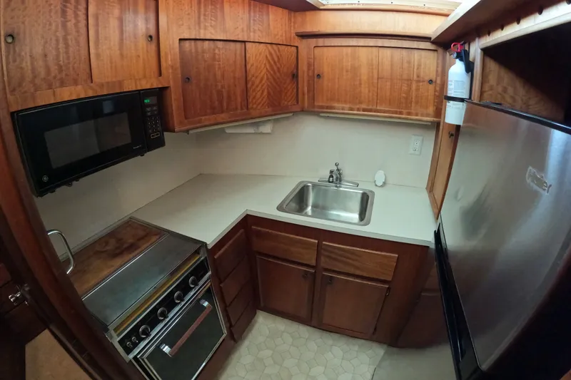 Slide: The Image of 1976 Hatteras 38 Double Cabin kitchen with wooden cabinets. - 21