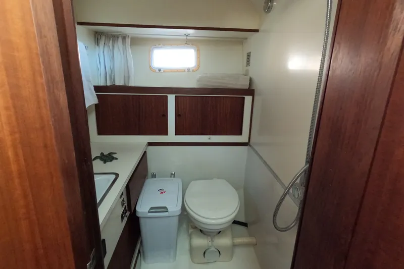 Slide: The Image of 1976 Hatteras 38 Double Cabin bathroom with toilet and shower. - 22