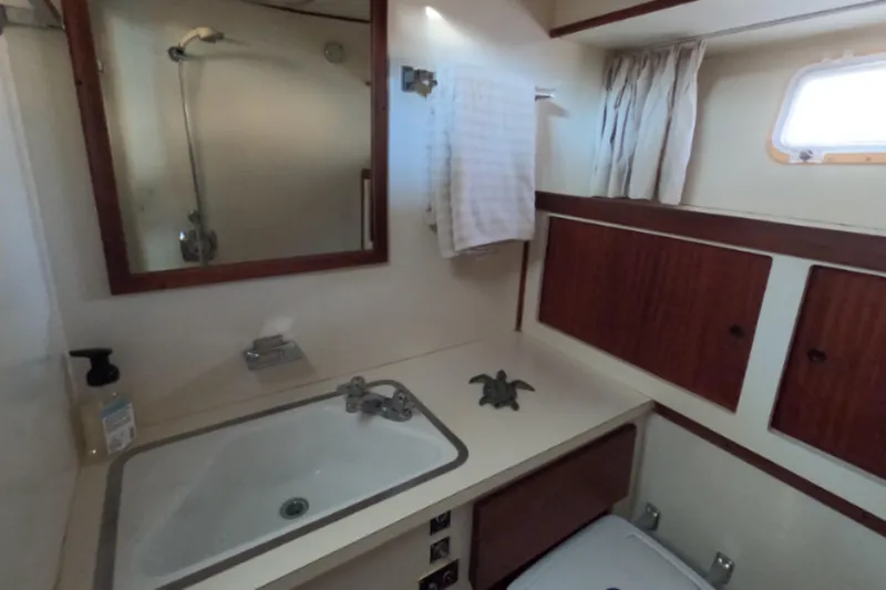 Slide: The Image of Interior of 1976 Hatteras 38 Double Cabin, bathroom with sink and mirror. - 23
