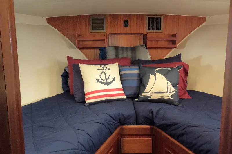 Slide: The Image of Interior of 1976 Hatteras 38 Double Cabin with nautical-themed pillows. - 24