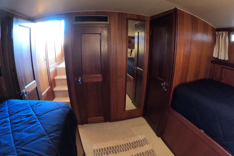 Slide: The Image of Interior of 1976 Hatteras 38 Double Cabin with wood paneling and beds. - 28