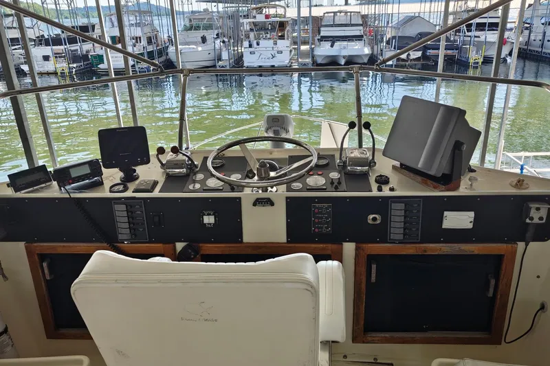 Slide: The Image of Helm of a 1976 Hatteras 38 Double Cabin yacht in a marina. - 7