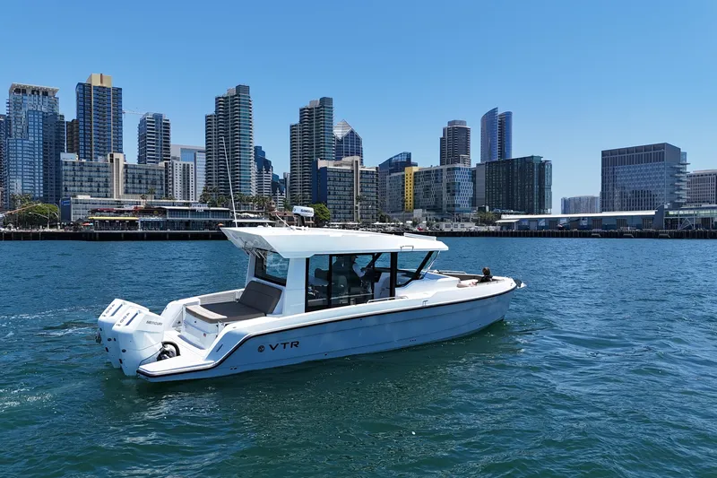 The Image of 2026 Cruisers Yachts 38 VTR on water with city skyline backdrop. - 0