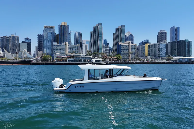 Slide: The Image of 2026 Cruisers Yachts 38 VTR on water with city skyline backdrop. - 1