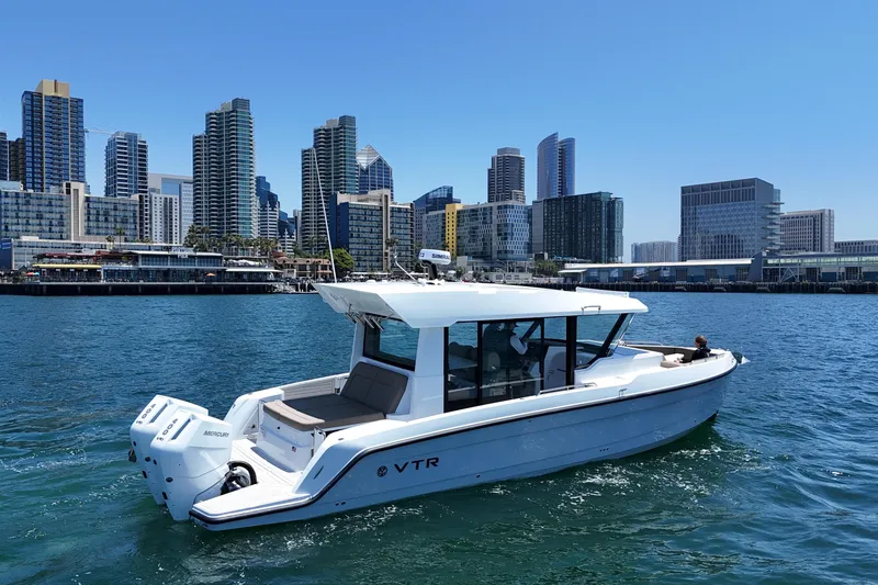 Slide: The Image of 2026 Cruisers Yachts 38 VTR on water with city skyline backdrop. - 10