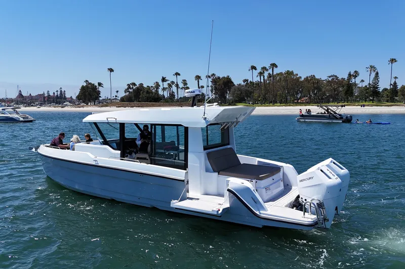 Slide: The Image of 2026 Cruisers Yachts 38 VTR on water, near beach with palm trees in background. - 11