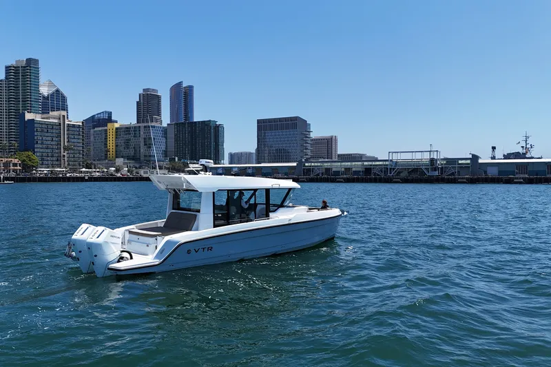 Slide: The Image of 2026 Cruisers Yachts 38 VTR on water with city skyline backdrop. - 12