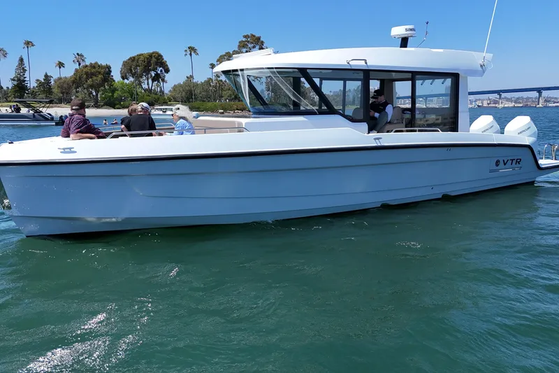 Slide: The Image of 2026 Cruisers Yachts 38 VTR on water with passengers, scenic background. - 13
