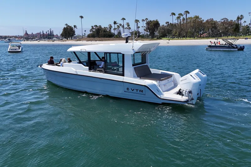 Slide: The Image of 2026 Cruisers Yachts 38 VTR on water, near scenic shoreline with palm trees. - 14