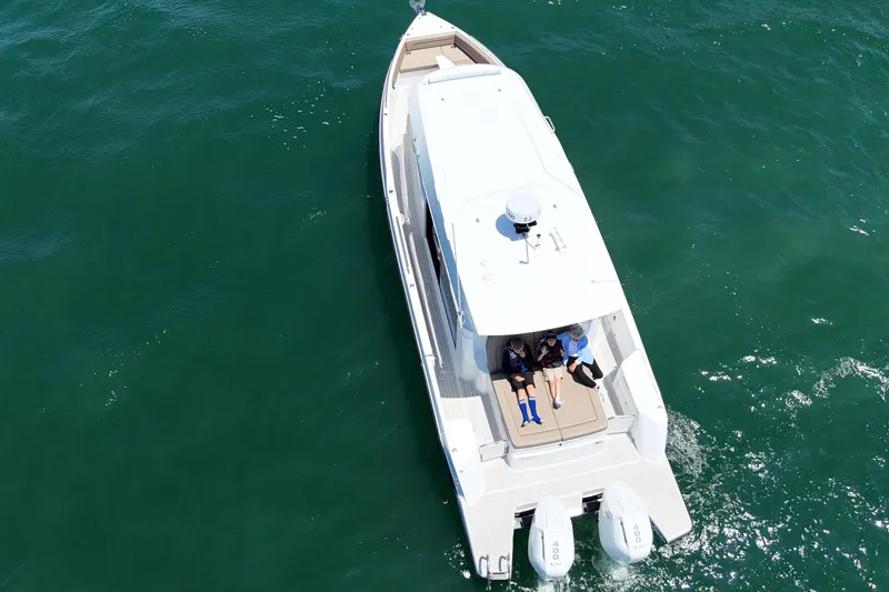 Slide: The Image of Aerial view of 2026 Cruisers Yachts 38 VTR on open water with passengers relaxing. - 17