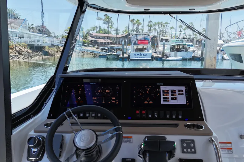 Slide: The Image of Cockpit view of 2026 Cruisers Yachts 38 VTR, featuring advanced navigation displays. - 19