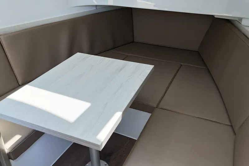 Slide: The Image of Interior seating area of 2026 Cruisers Yachts 38 VTR with a sleek table. - 26