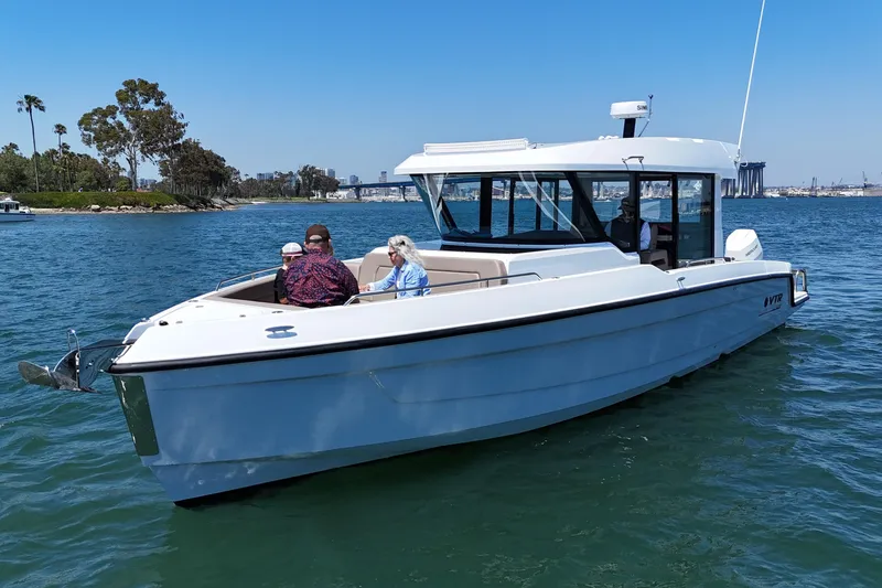 Slide: The Image of 2026 Cruisers Yachts 38 VTR on water with passengers, scenic backdrop. - 3