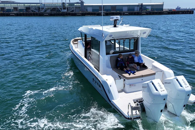 Slide: The Image of Cruisers Yachts 38 VTR 2026 on water, featuring twin Mercury engines, dockside view. - 4
