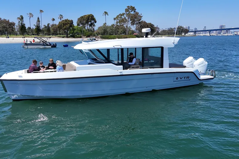Slide: The Image of 2026 Cruisers Yachts 38 VTR on water with passengers, scenic background. - 5