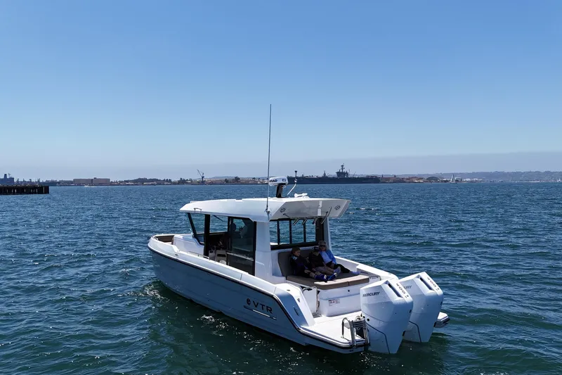 Slide: The Image of 2026 Cruisers Yachts 38 VTR on open water, clear sky, distant shoreline. - 6