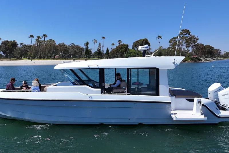 Slide: The Image of 2026 Cruisers Yachts 38 VTR on water with passengers, scenic shoreline background. - 7