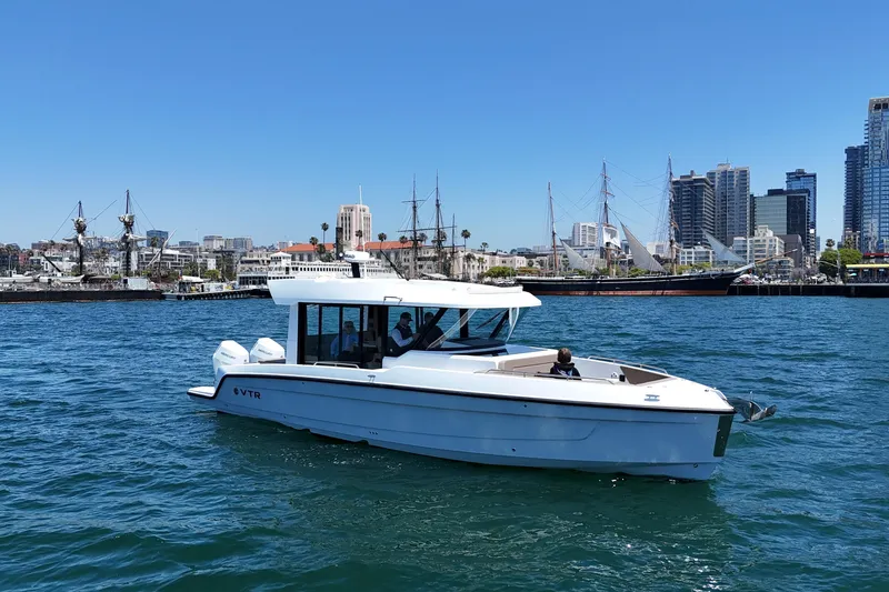Slide: The Image of 2026 Cruisers Yachts 38 VTR on water with city skyline in background. - 9