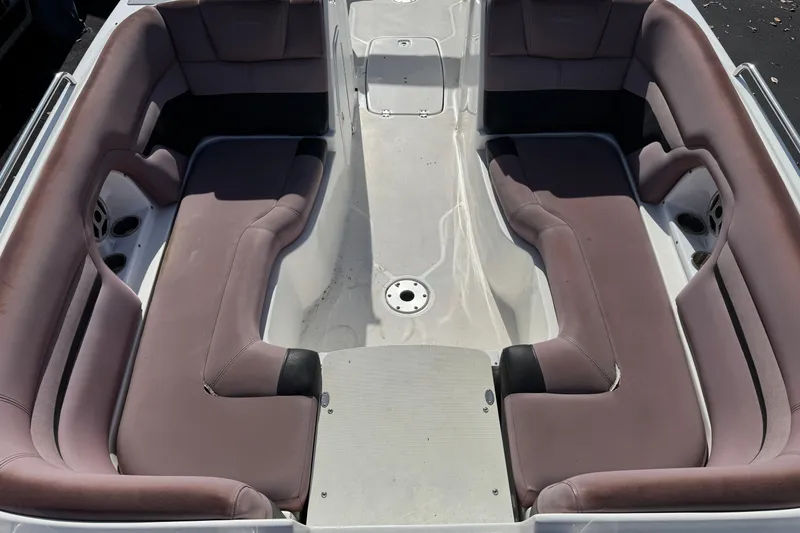 Slide: The Image of 2018 Hurricane SunDeck 2400 OB boat interior with spacious seating and cup holders. - 11