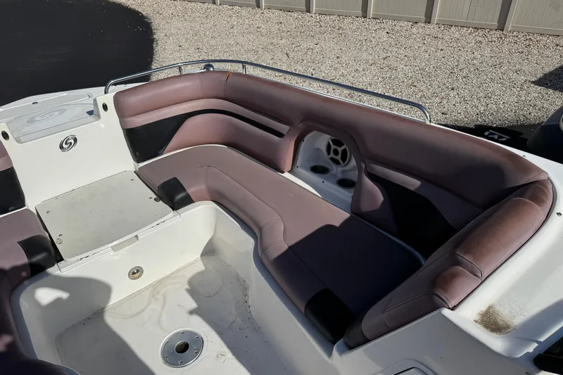 Slide: The Image of 2018 Hurricane SunDeck 2400 OB boat interior with spacious seating and cup holders. - 13