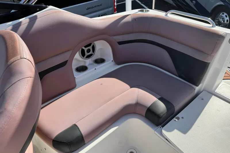 Slide: The Image of 2018 Hurricane SunDeck 2400 OB boat interior seating with cup holders and speaker. - 16