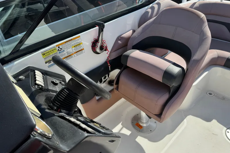 Slide: The Image of 2018 Hurricane SunDeck 2400 OB boat cockpit with steering wheel and comfortable seating. - 17