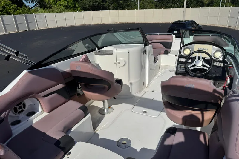 Slide: The Image of 2018 Hurricane SunDeck 2400 OB boat interior with plush seating and modern dashboard. - 18