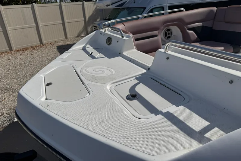 Slide: The Image of 2018 Hurricane SunDeck 2400 OB boat deck with seating and storage compartments. - 19