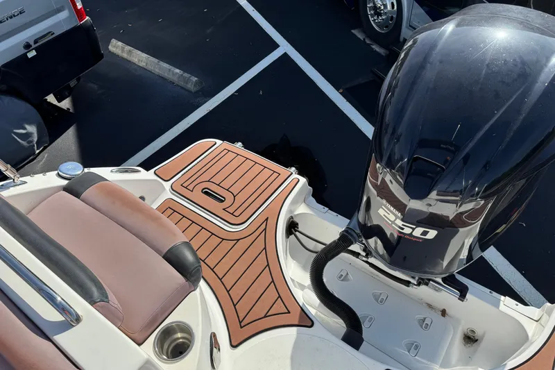 Slide: The Image of 2018 Hurricane SunDeck 2400 OB boat with Yamaha 250 outboard motor, parked on asphalt. - 20