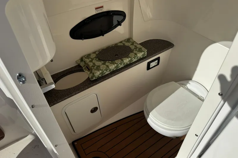 Slide: The Image of 2018 Hurricane SunDeck 2400 OB boat bathroom with toilet and countertop. - 22