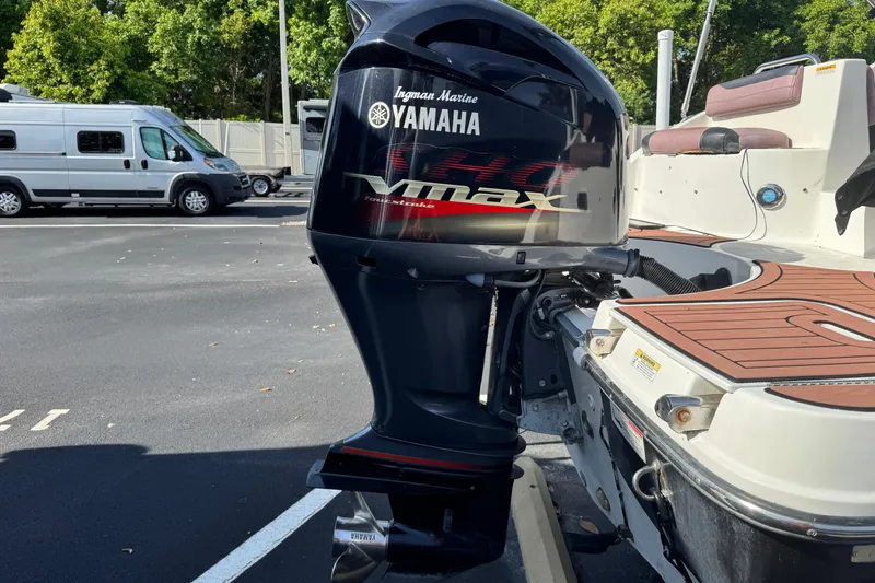 Slide: The Image of 2018 Hurricane SunDeck 2400 OB with Yamaha VMAX outboard motor in parking lot. - 4