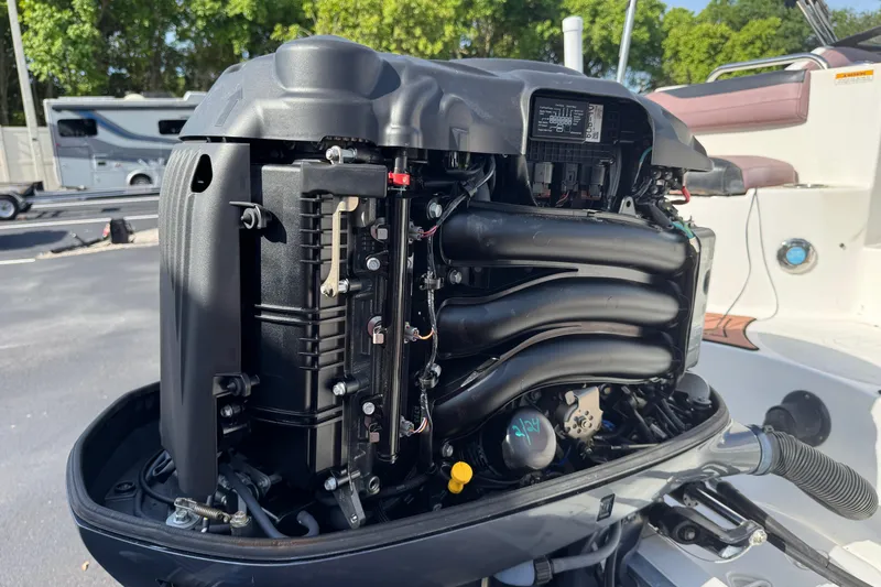 Slide: The Image of 2018 Hurricane SunDeck 2400 OB outboard engine, detailed view, parked outdoors. - 7