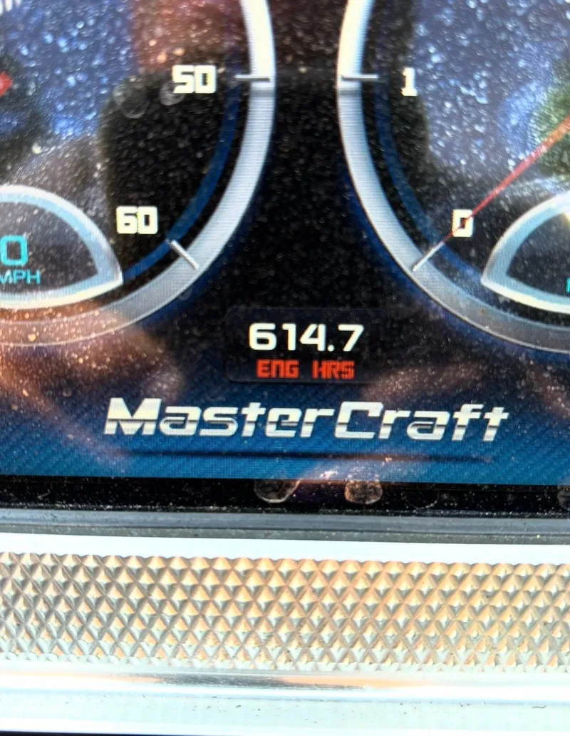 Slide: The Image of MasterCraft XStar 2013 dashboard showing 614.7 engine hours. - 11