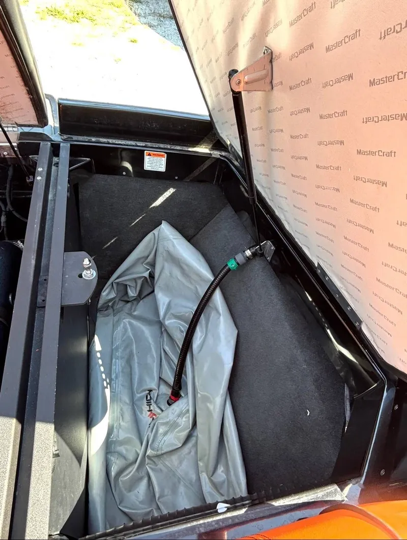 Slide: The Image of MasterCraft XStar 2013 storage compartment with ballast tank and hose. - 12