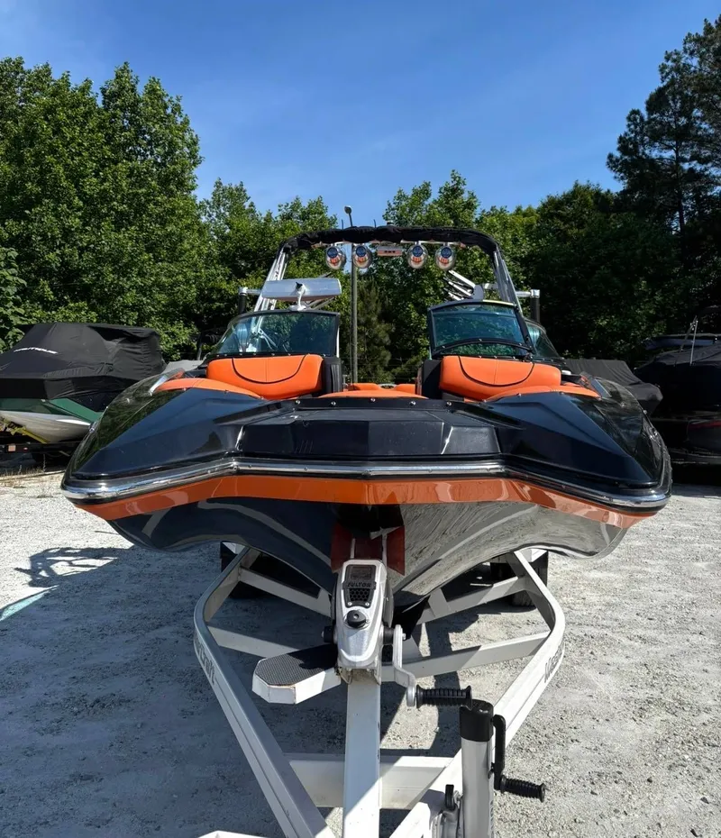 Slide: The Image of 2013 MasterCraft XStar boat on trailer outdoors. - 13