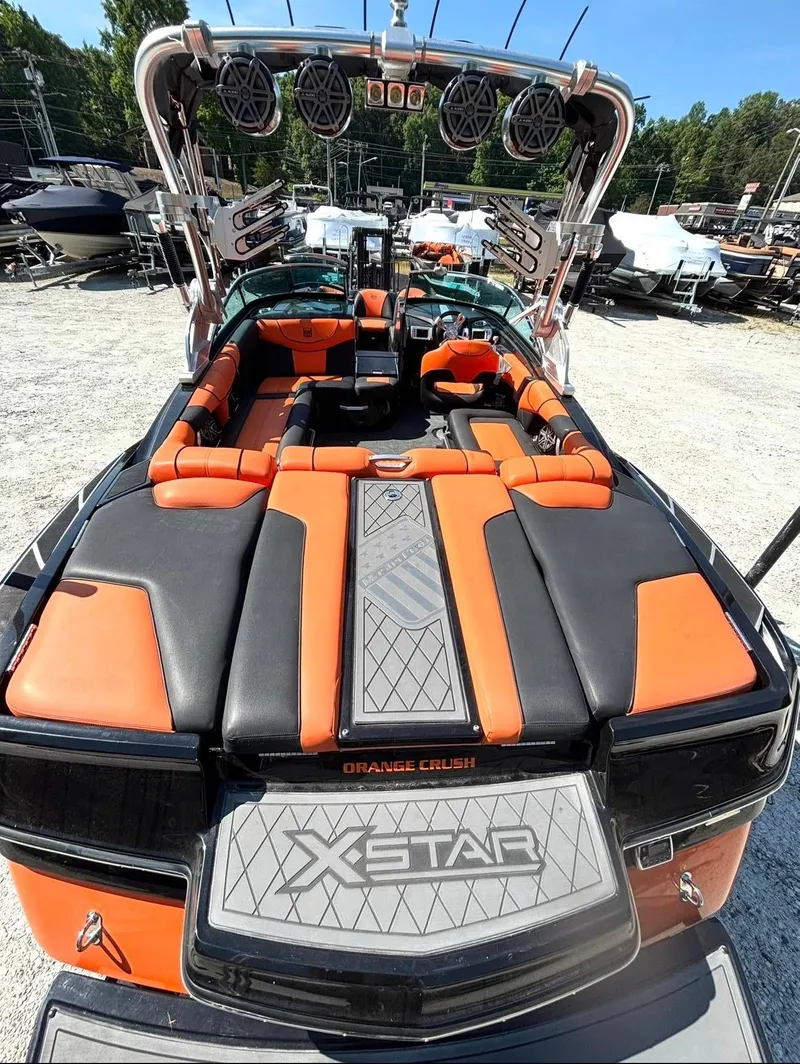 Slide: The Image of 2013 MasterCraft XStar boat with orange and black interior. - 4