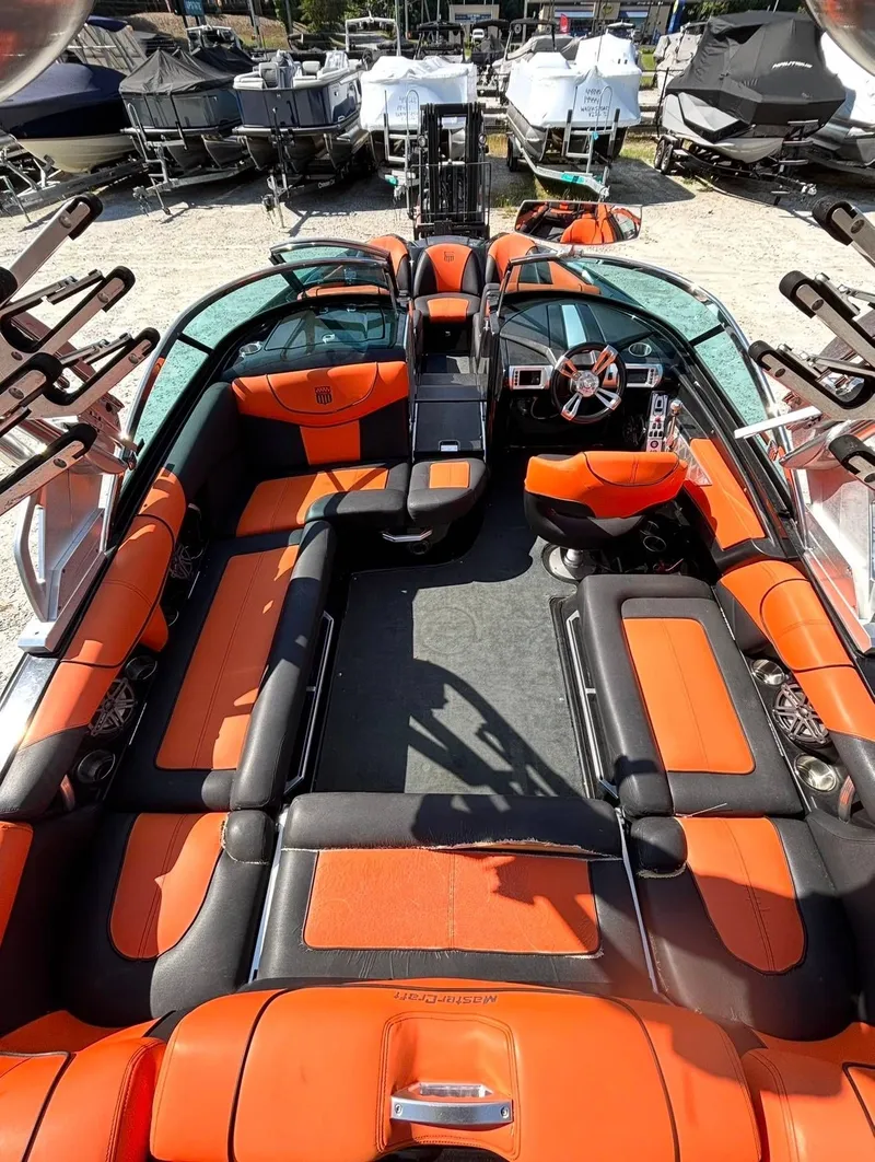 Slide: The Image of Interior of a 2013 MasterCraft XStar boat with orange seating. - 5