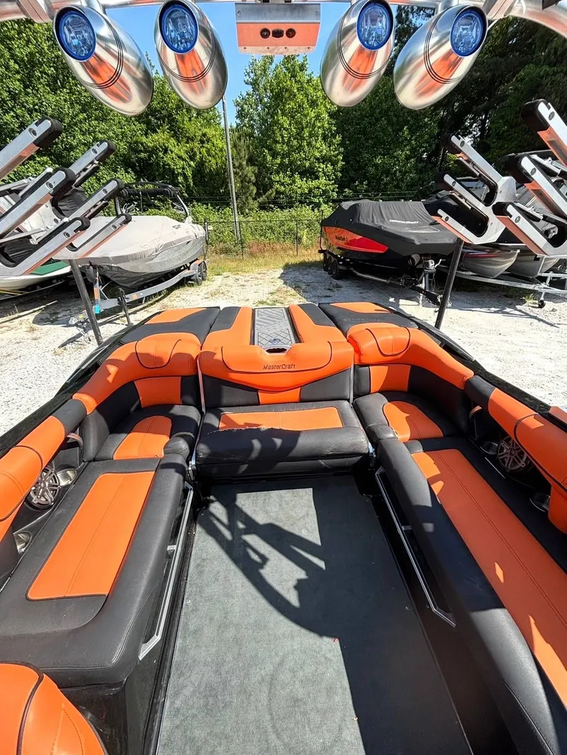 Slide: The Image of Interior of a 2013 MasterCraft XStar with orange and black seating. - 6