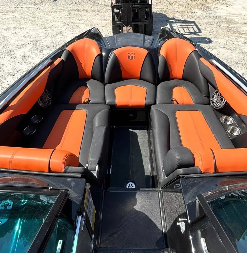 Slide: The Image of Interior of a 2013 MasterCraft XStar with orange and black seating. - 8