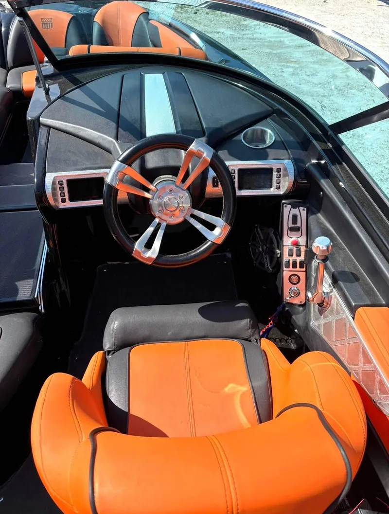 Slide: The Image of Interior of a 2013 MasterCraft XStar boat with orange seats. - 9