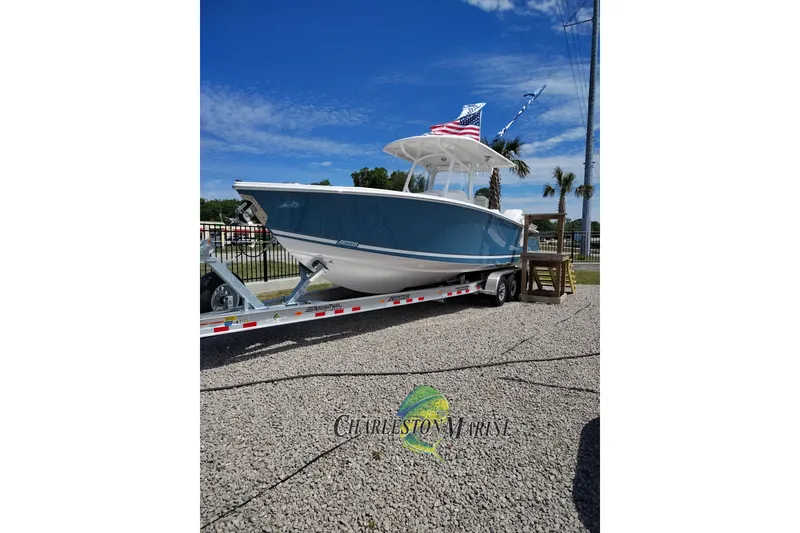 The Image of 2026 Jupiter 30 boat on trailer with American flag, displayed at Charleston Marine. - 0
