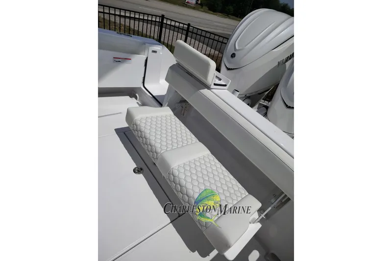 Slide: The Image of White seating on a 2026 Jupiter 30 boat, featuring a quilted design and dual engines. - 10