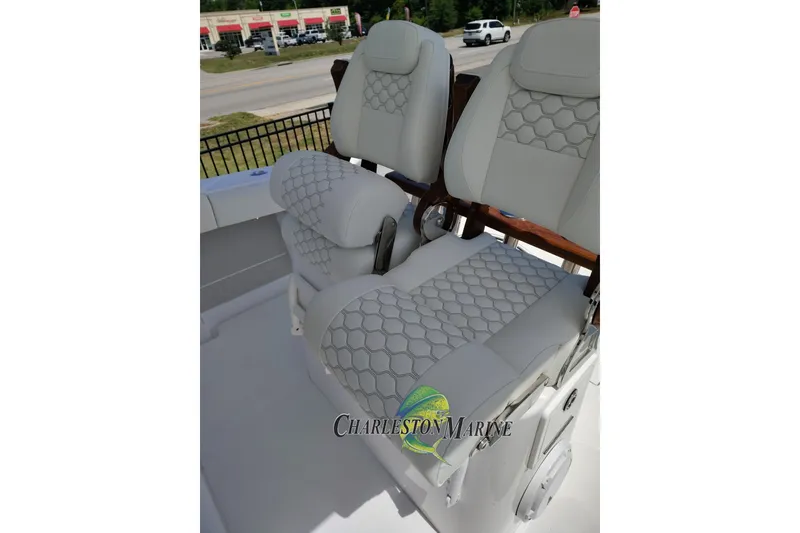 Slide: The Image of Luxurious seating on a 2026 Jupiter 30 boat, featuring elegant hexagonal stitching. - 11