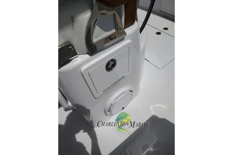 Slide: The Image of 2026 Jupiter 30 boat console with storage compartment and speaker, Charleston Marine logo visible. - 12