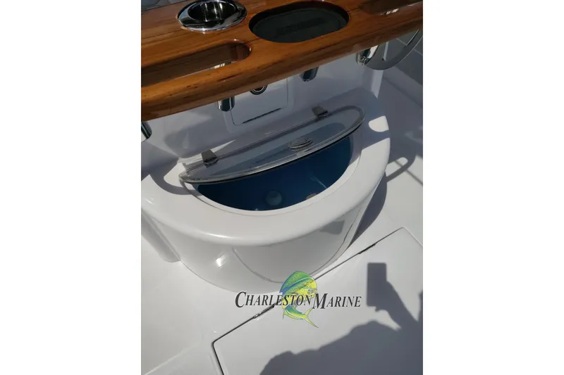 Slide: The Image of 2026 Jupiter 30 boat console with wooden accents and open storage compartment. - 13